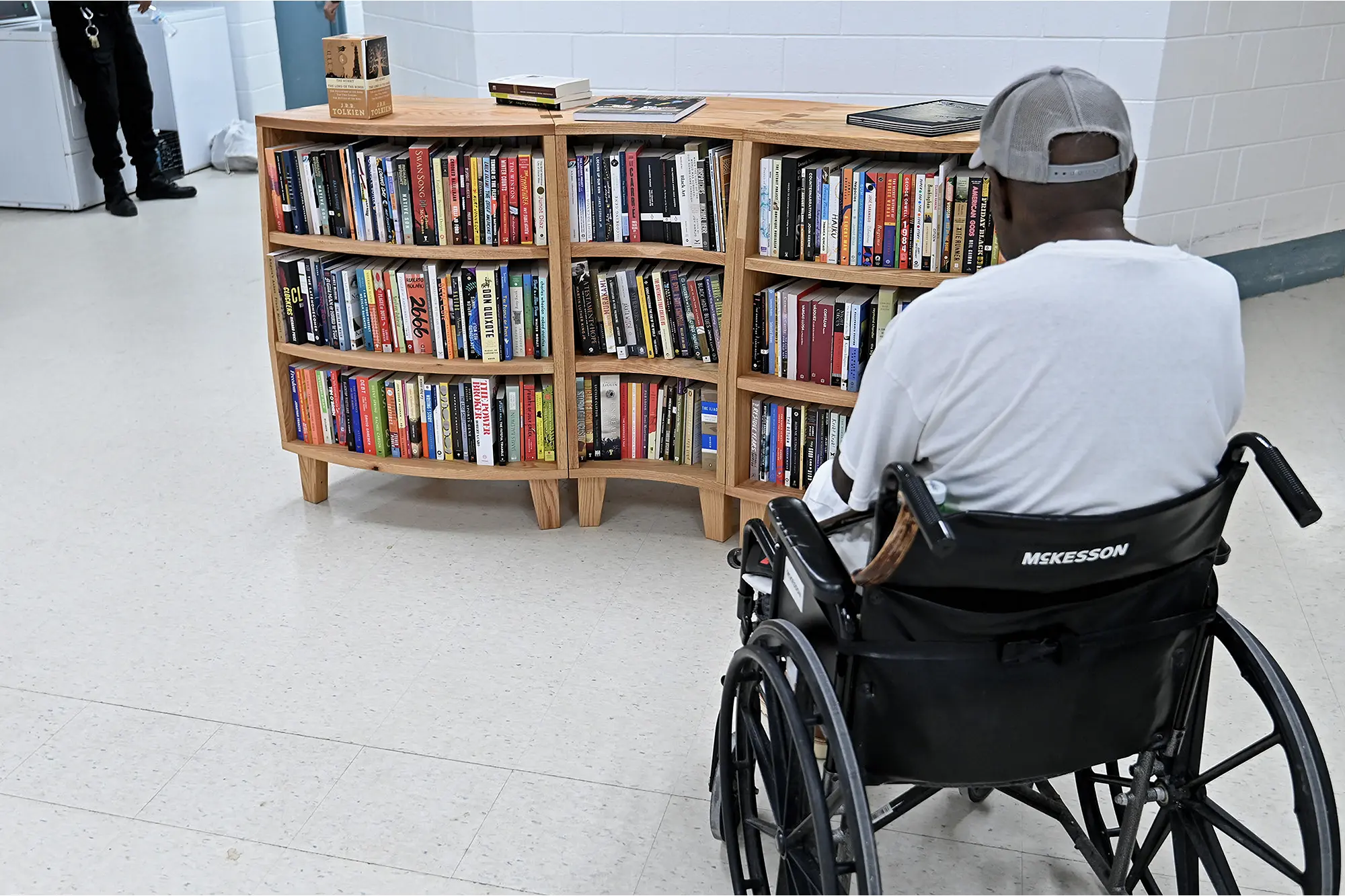 An elderly Freedom Library Patron sits and contemplates one of the brand new, maple wood Freedom Libraries opened at Dorsey Run Correctional Facility in Maryland.