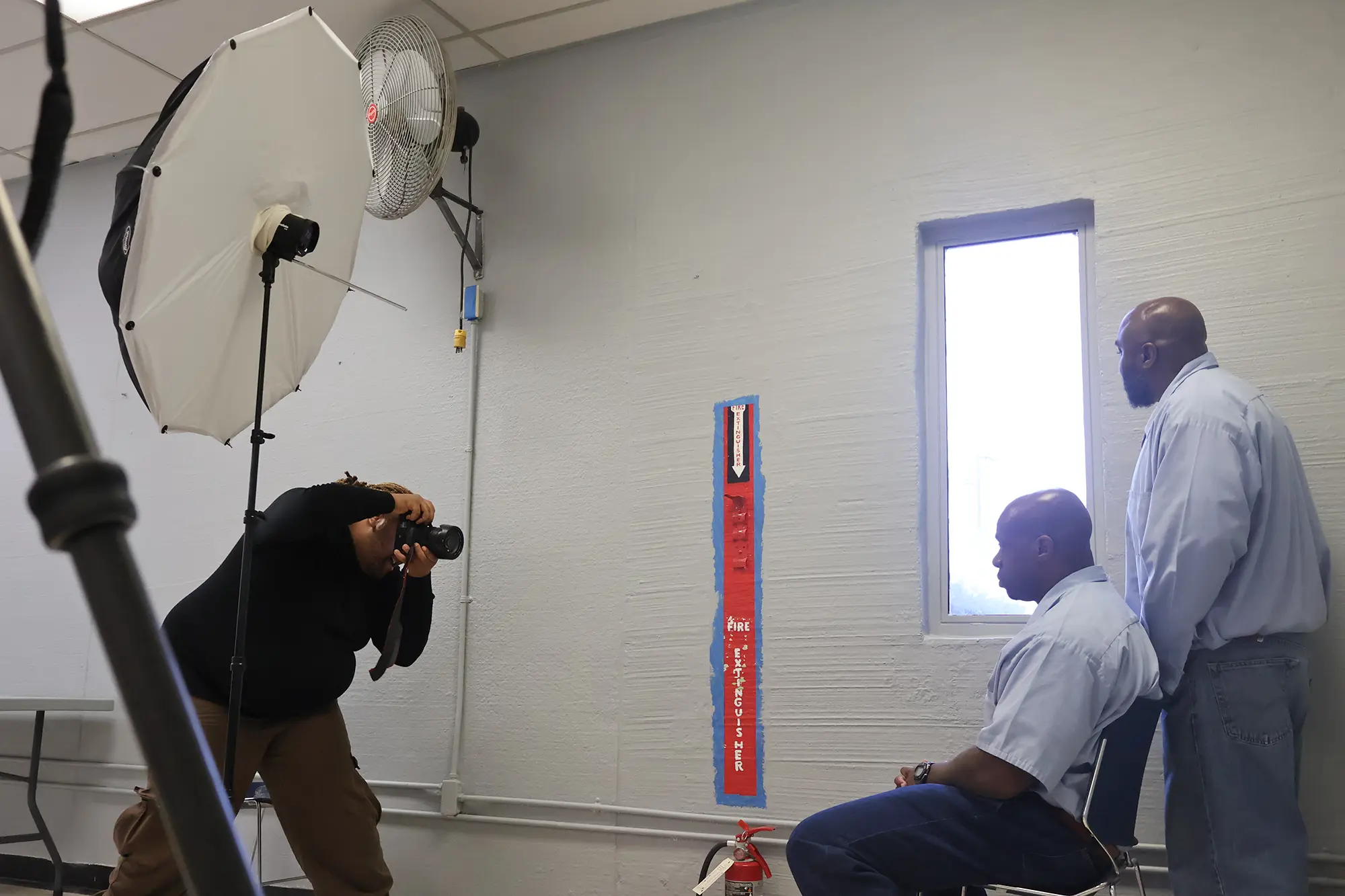 Two incarcerated men pose in the light of a lone window for portrait photographer Gioncarlo Valentine inside Buckingham Correctional Center.