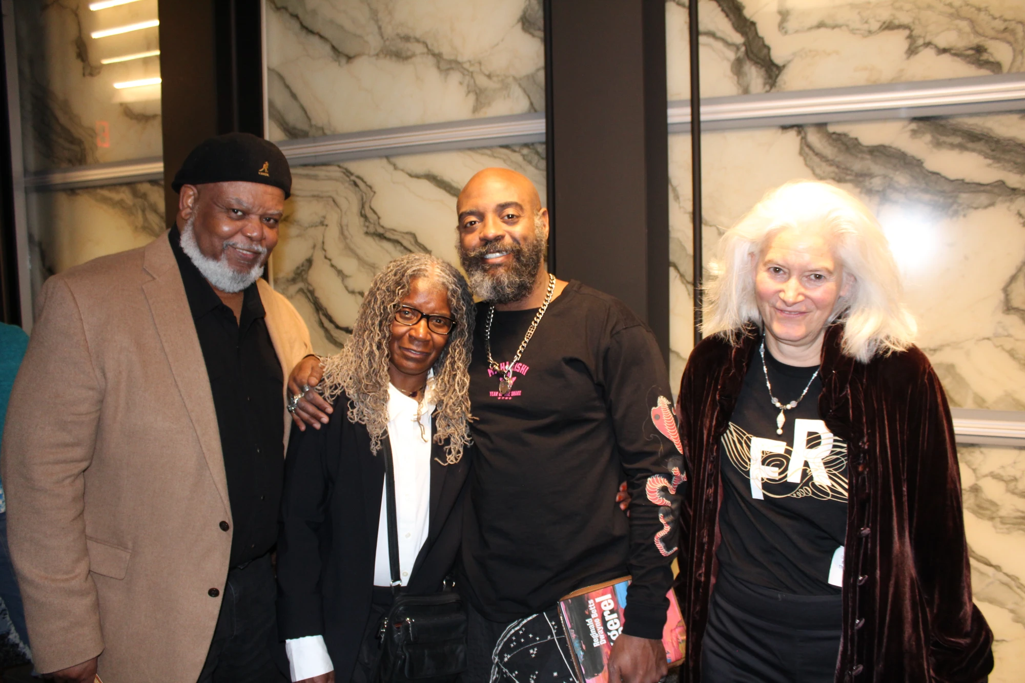 Freedom Reads Founder & CEO Reginald Dwayne Betts with family and friends after his March Forth performance at the Perelman Performing Arts Center in New York City this month. Freedom Reads Founder & CEO Reginald Dwayne Betts stands with three people, family and friends, smiling after his March Forth performance at the Perelman Performing Arts Center in New York City this month.