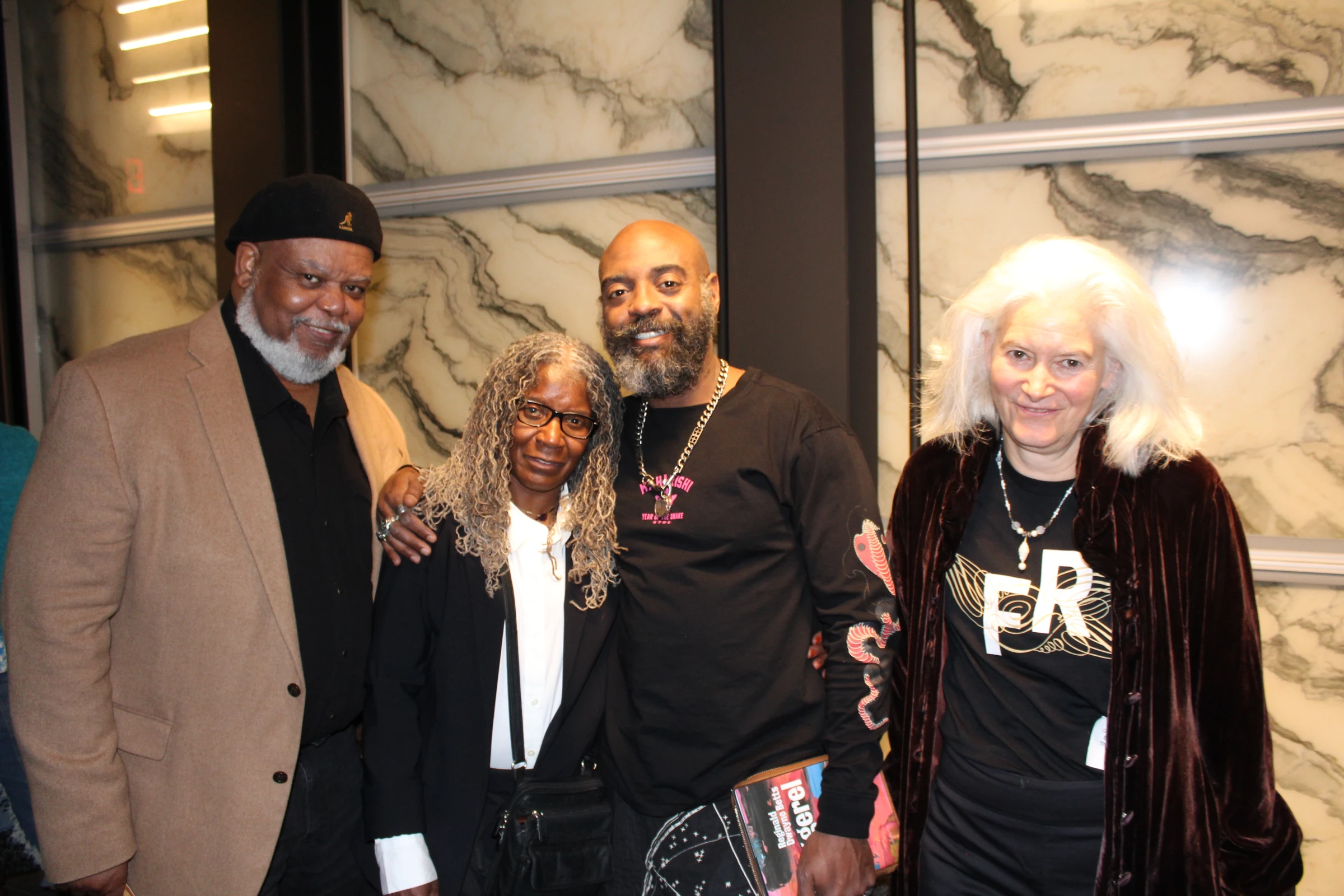 Freedom Reads Founder & CEO Reginald Dwayne Betts with family and friends after his March Forth performance at the Perelman Performing Arts Center in New York City this month. Freedom Reads Founder & CEO Reginald Dwayne Betts stands with three people, family and friends, smiling after his March Forth performance at the Perelman Performing Arts Center in New York City this month.