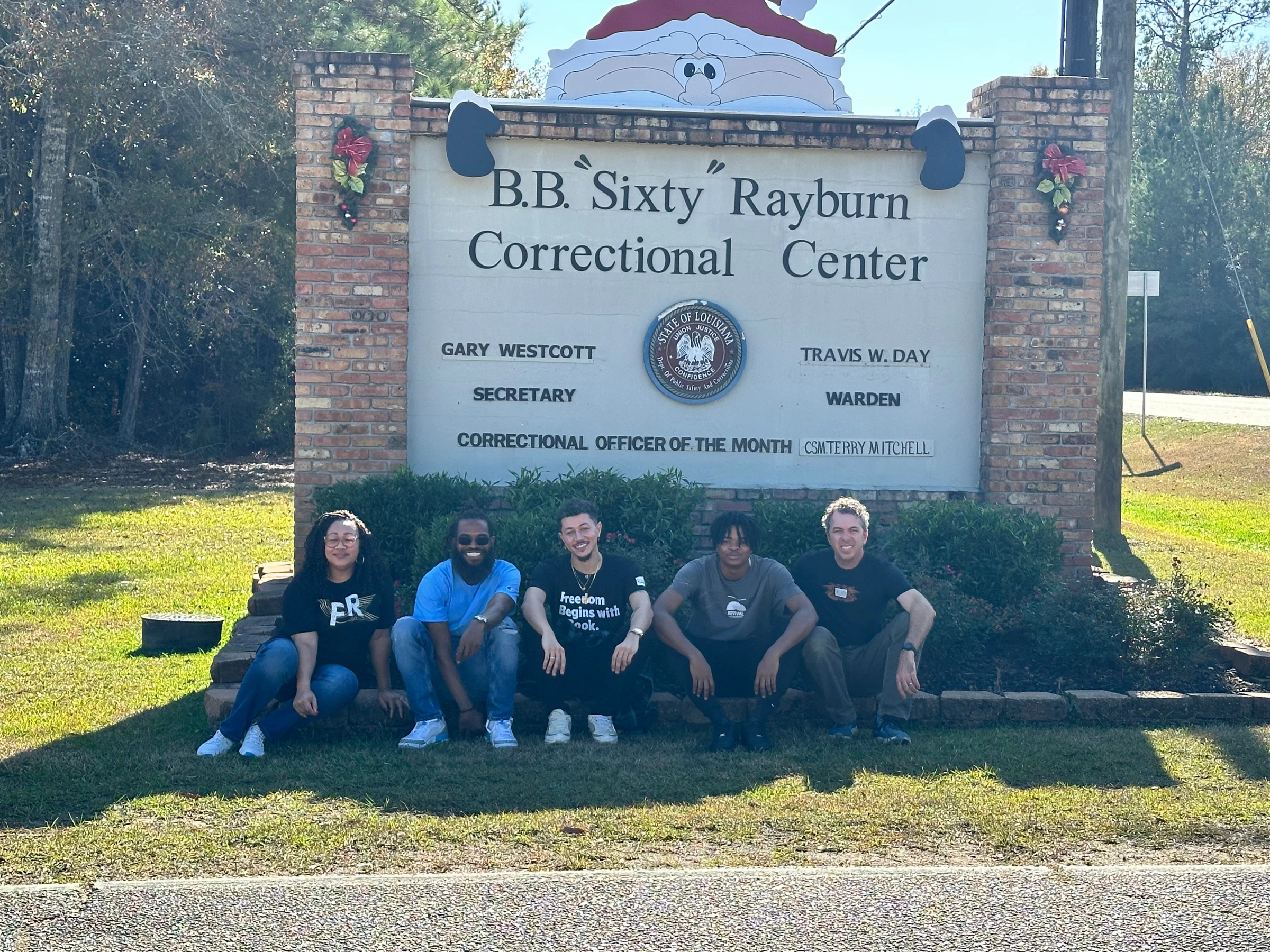 The Freedom Reads team opened six additional Freedom Libraries at Rayburn Correctional Center in Louisiana this December. Five members of the Freedom Reads team sit in front of the sign for Rayburn Correctional Center wearing Freedom Reads t-shirts.