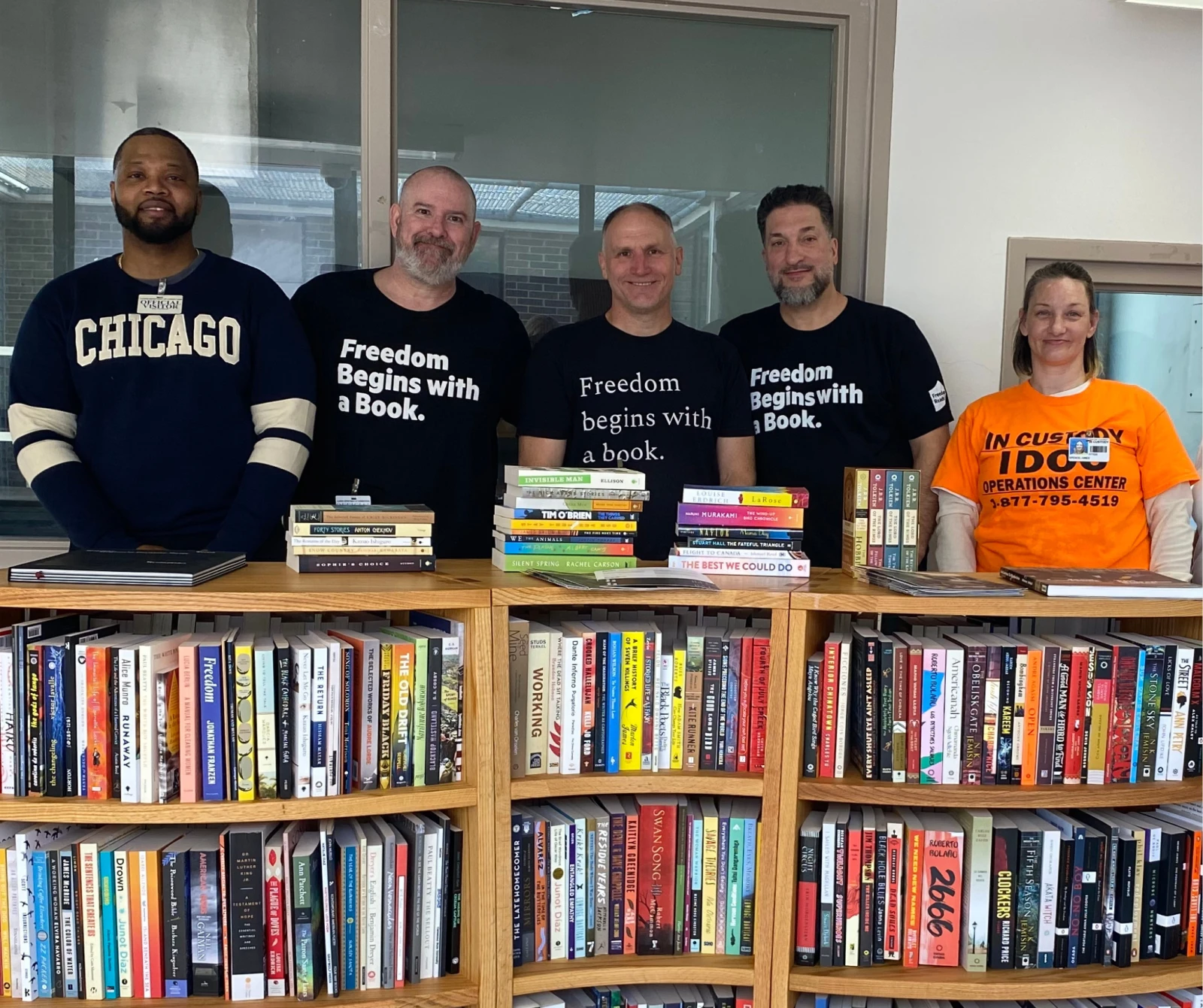 Freedom Reads team members standing in front of Freedom Library