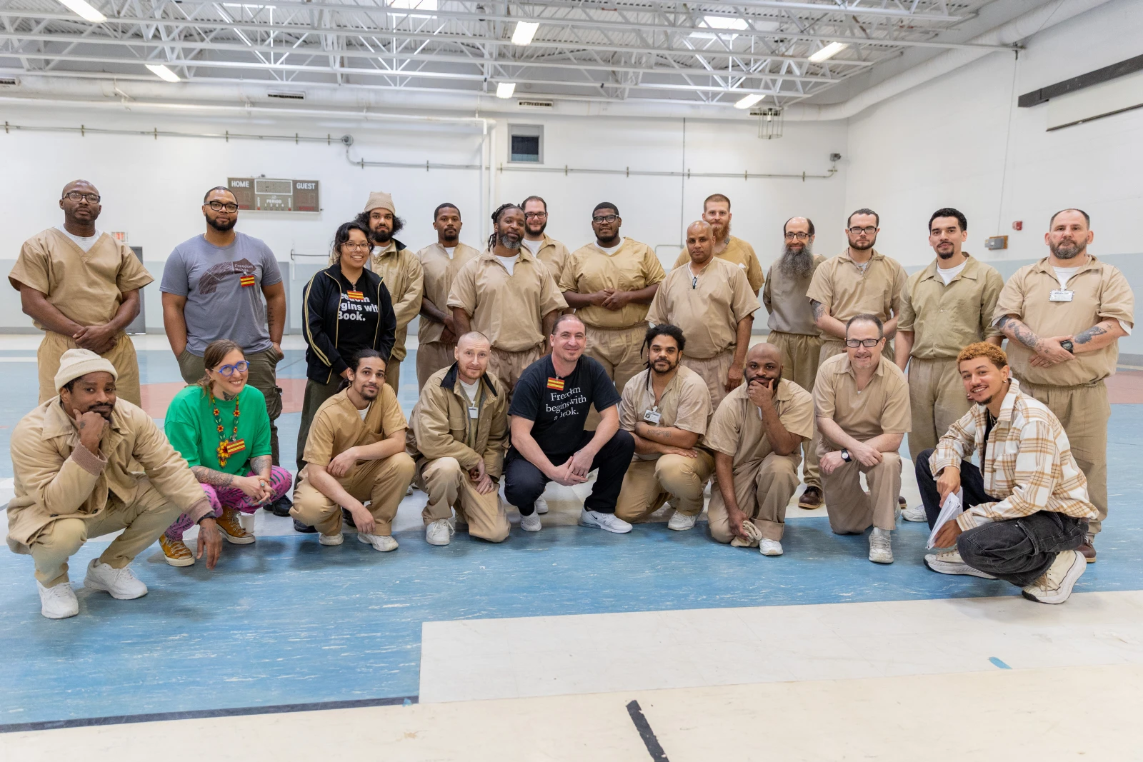 The Freedom Reads team, author Caits Meissner, and Inside Literary Prize judges at Northern State Prison in New Jersey. Group photo with almost twenty men wearing khaki prison uniforms and the freedom reads team in black and gray t-shirts.