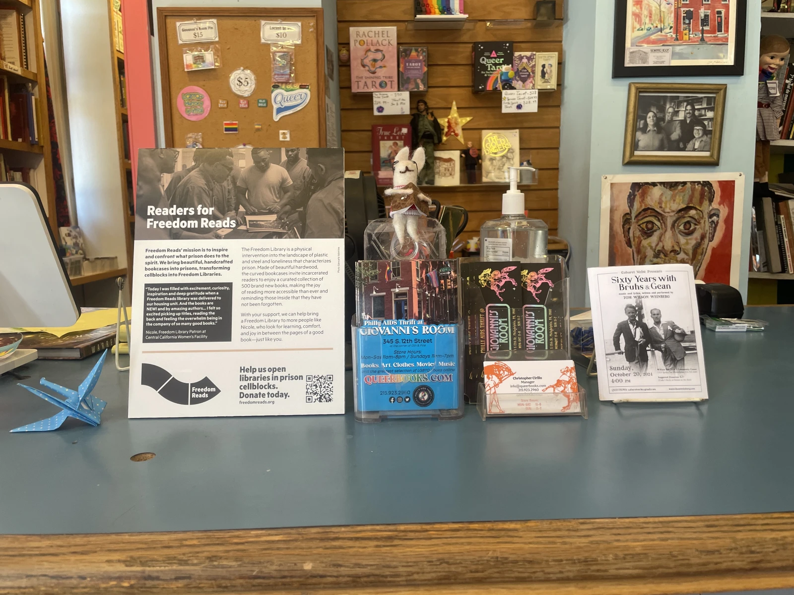 A Readers for Freedom Reads poster at Philly AIDS Thrift @ Giovanni's Room bookstore in Philadelphia. A Readers for Freedom Reads poster on a bookstore counter next to other flyers.