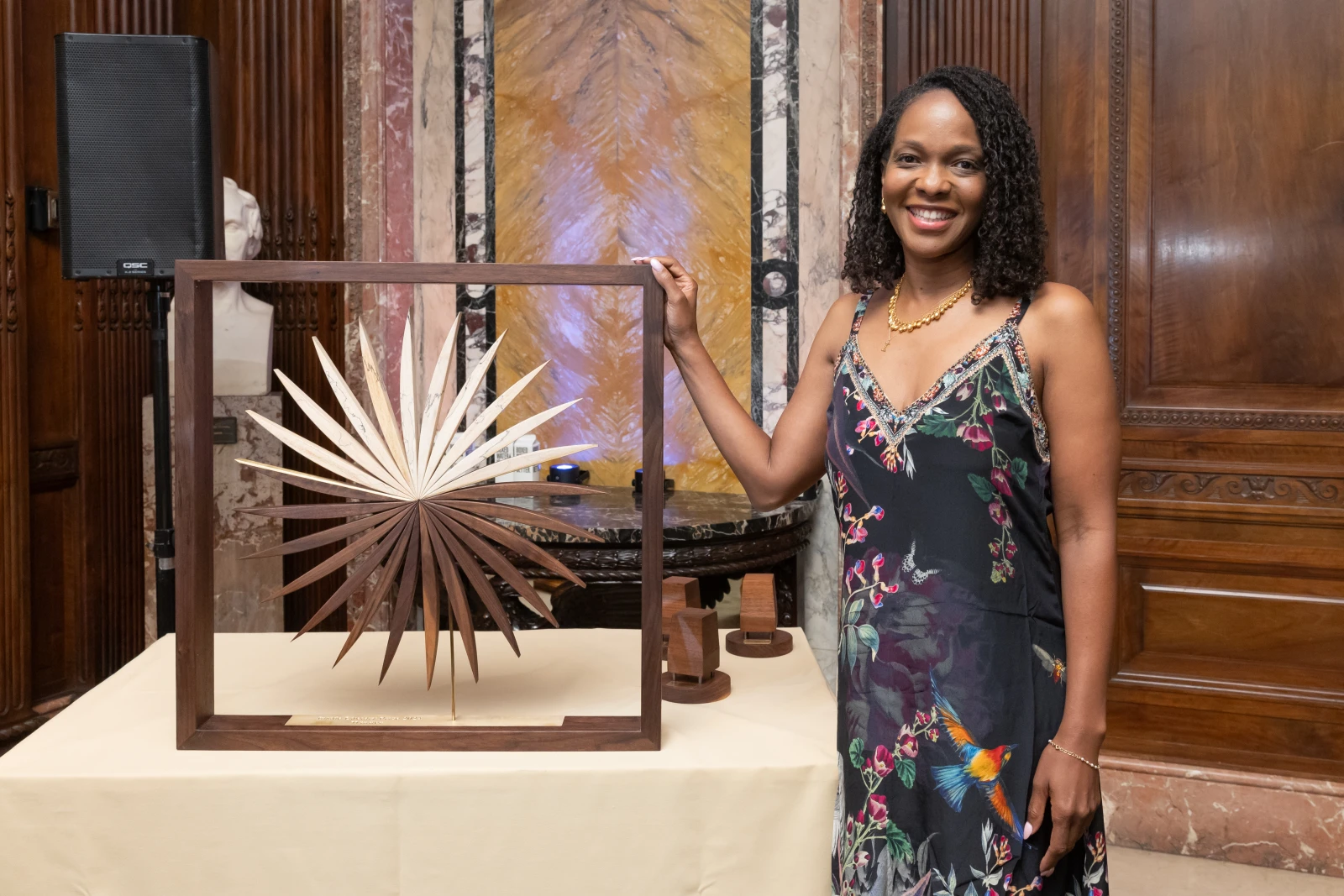 On August 1, 2024, Imani Perry, author of *South to America: A Journey Below the Mason-Dixon to Understand the Soul of a Nation*, was awarded the inaugural Inside Literary Prize. Imani Perry stands, smiling with the Inside Literary Prize award.